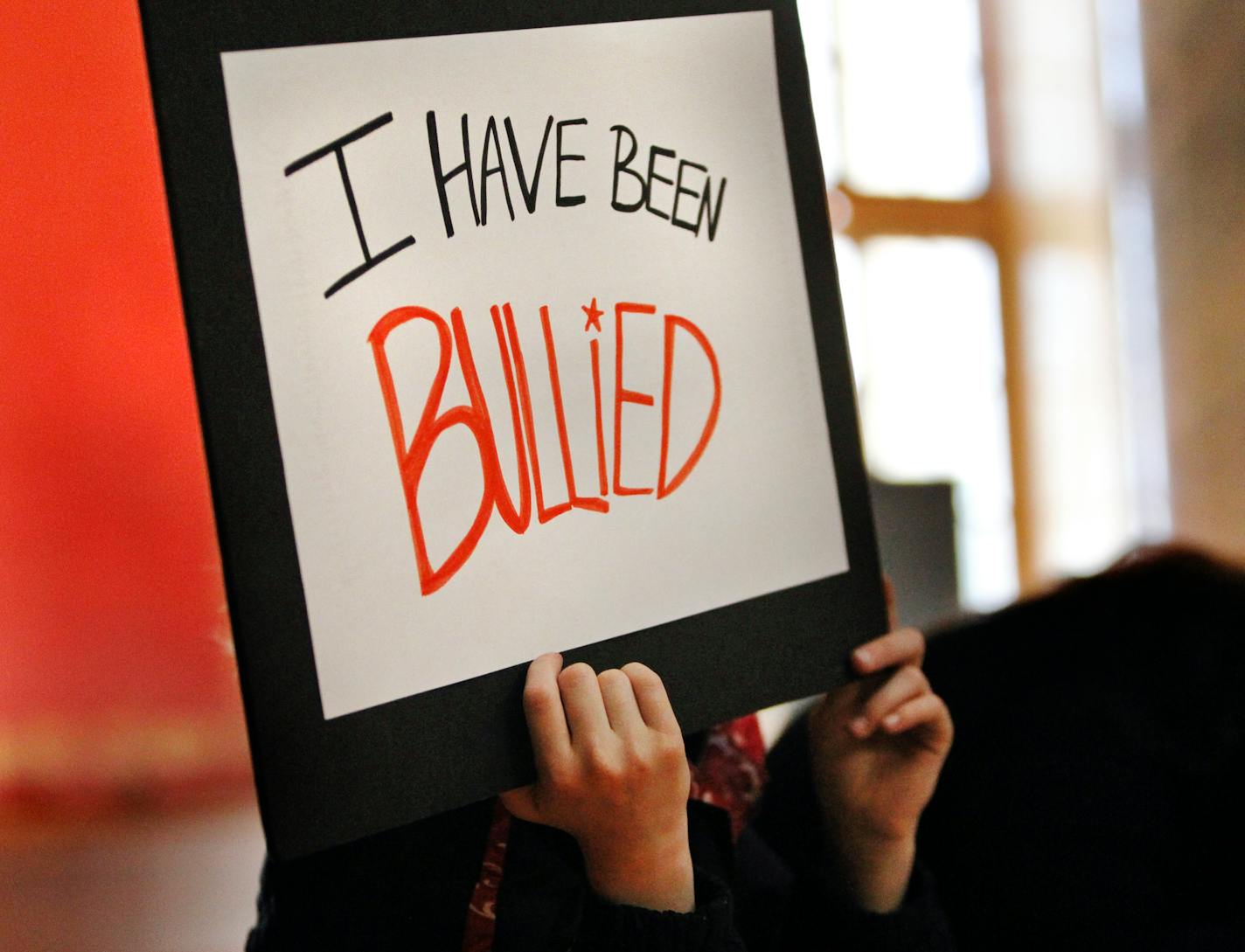 A child holds up a sign at an anti-bullying rally at the Minnesota State Capitol on Saturday, Feb. 11, 2012, in St. Paul.