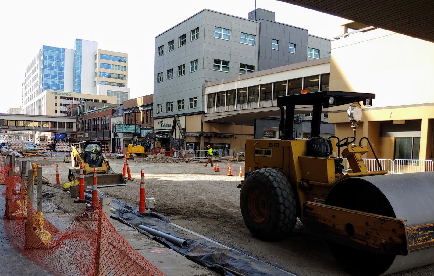 Workers prepared a section of W. Superior Street in downtown Duluth to be covered in asphalt through the winter before work on a permanent surface is finished next year.