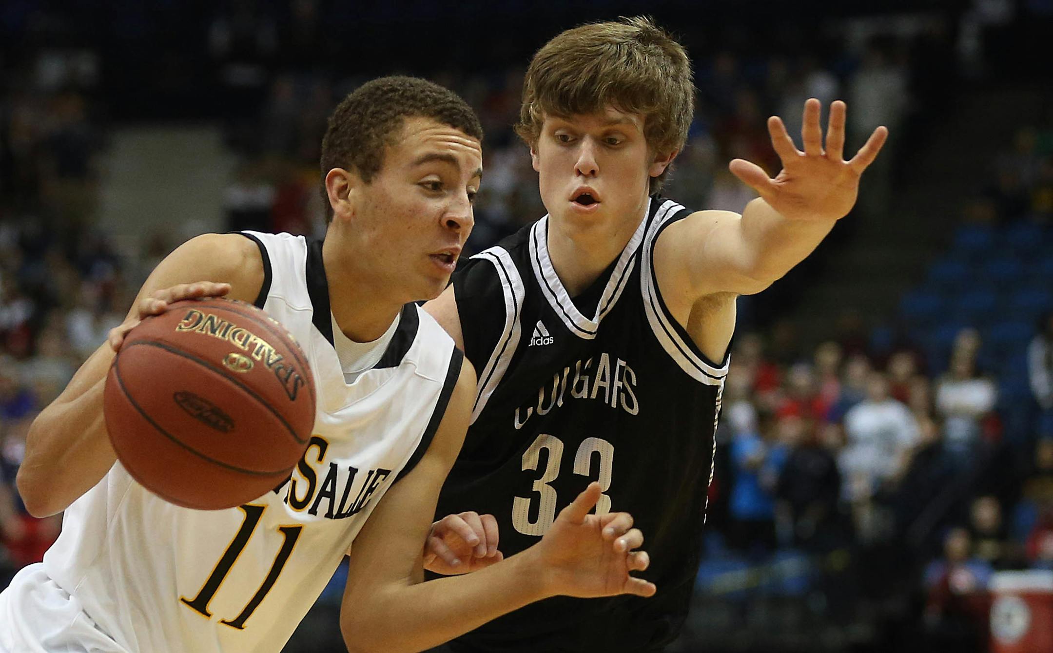 DeLaSalle's Gabe Kalscheur (left) drove to the basket against Mankato East's Sam Ahrens.