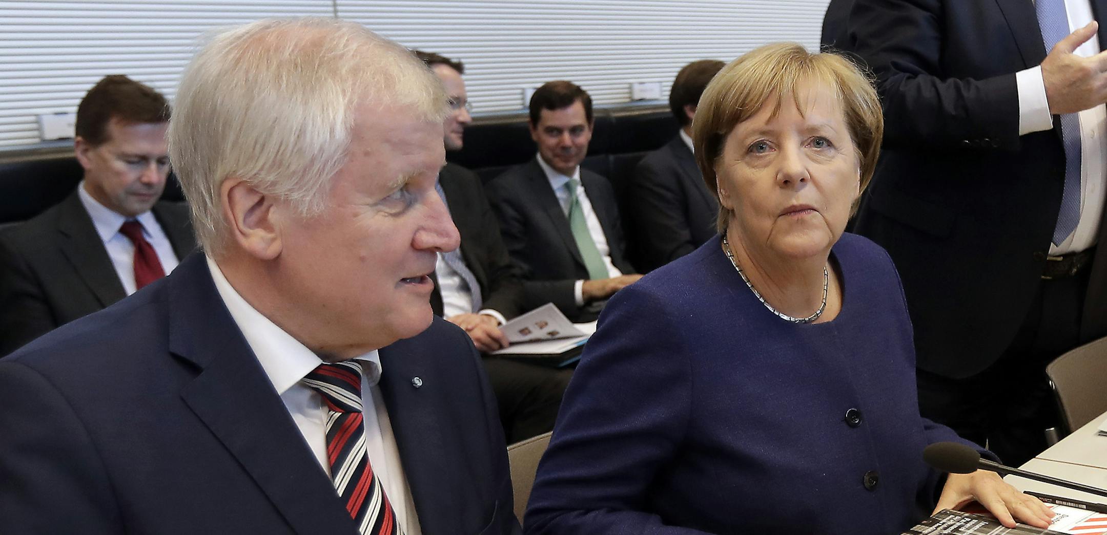 The German Chancellor and Chairwomen of the German Christian Democratic Party (CDU), Angela Merkel, right, and the chairman of the German Christian Social Union Party (CSU), Horst Seehofer, left,arrive for the parliamentary caucus of Merkel's conservative Union bloc in Berlin, Germany, Tuesday, Sept. 26, 2017. (AP Photo/Michael Sohn) ORG XMIT: MIN2017092611521923