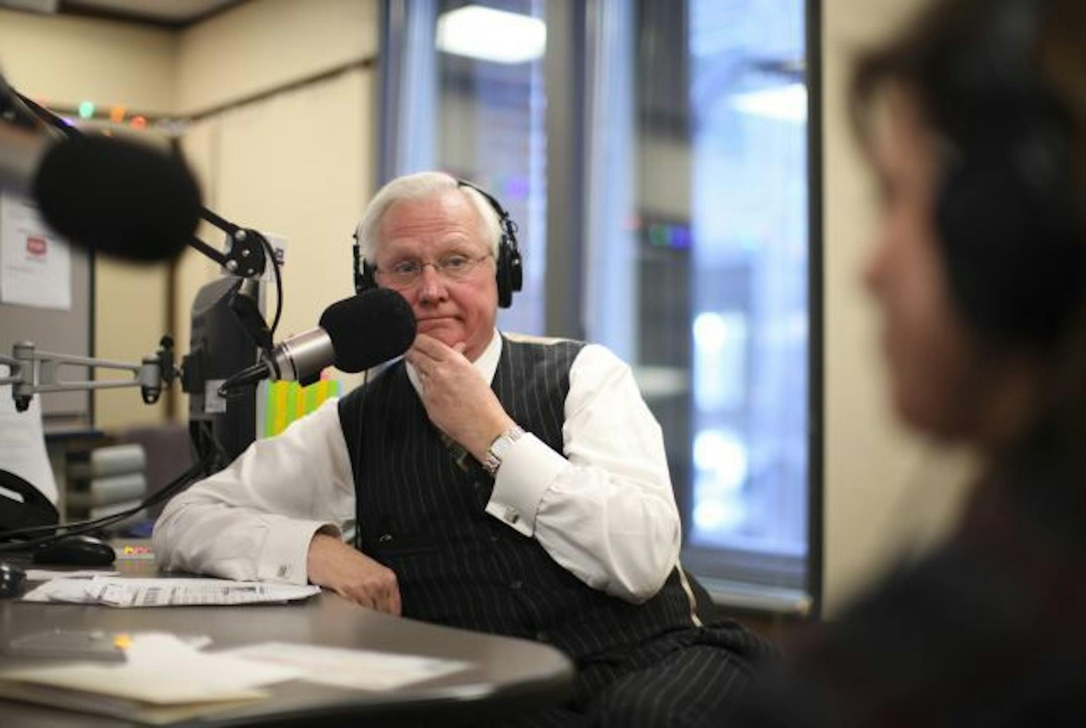 Don Shelby listened to Michele Tafoya, foreground, durng the final segment of his last radio show for WCCO AM Friday afternoon.
