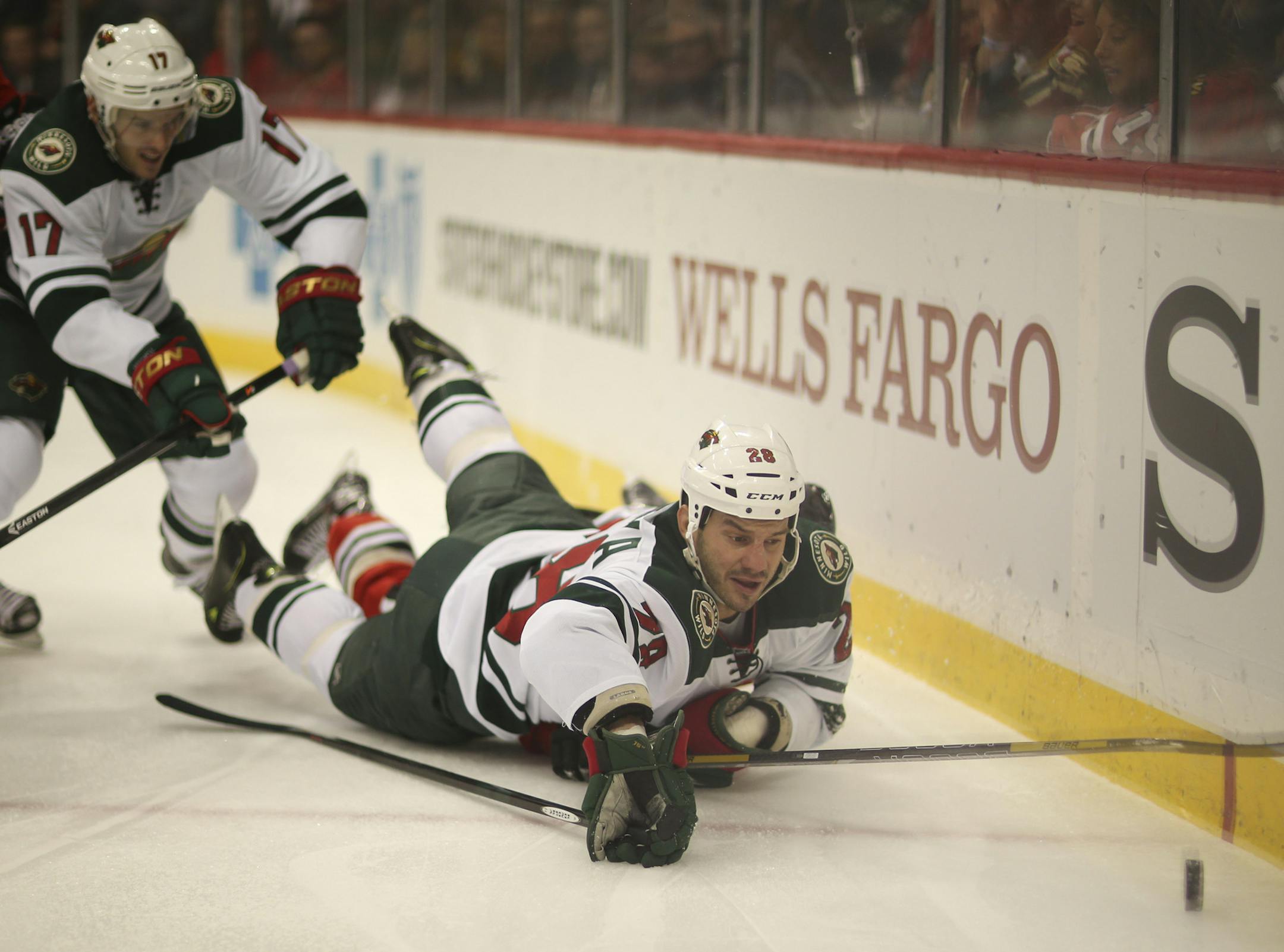 The Minnesota Wild met the Chicago Blackhawks in an NHL game Monday night, October 28, 2013 at Xcel Energy Center in St. Paul. Minnesota Wild center Zenon Konopka (28) and Chicago Blackhawks defenseman Nick Leddy (8) fought for control of the puck as they fell against the boards behind the Chicago net in the first period. ] JEFF WHEELER &#x201a;&#xc4;&#xa2; jeff.wheeler@startribune.com