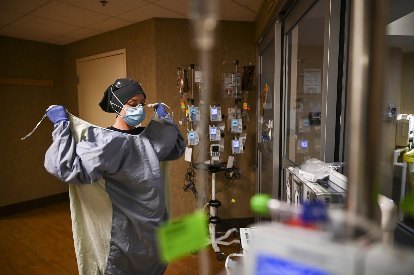 North Memorial Health Hospital critical care nurse Kayla Lynch donned a protective gown before entering the room of a COVID-19 patient during her shif