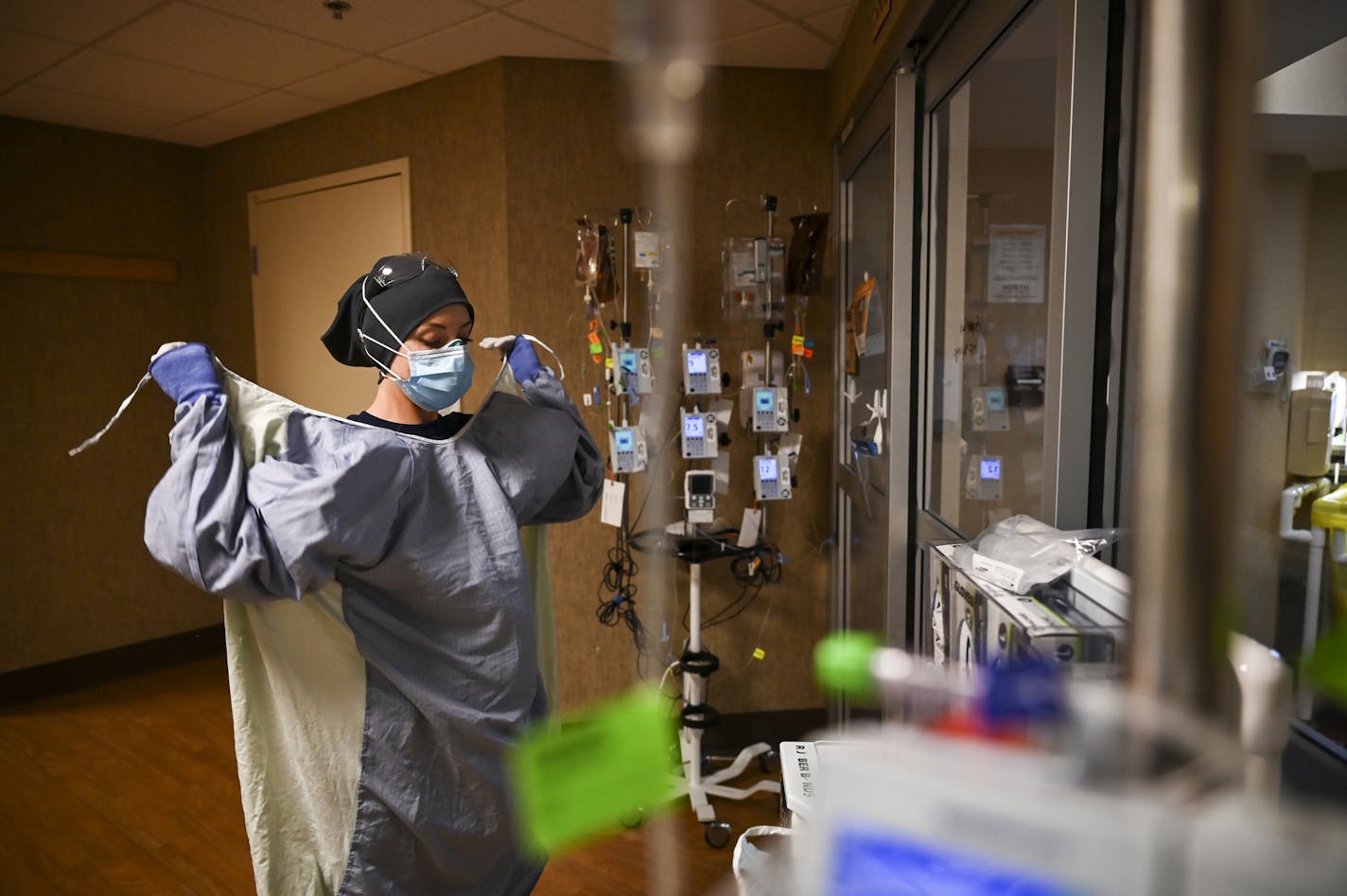 North Memorial Health Hospital critical care nurse Kayla Lynch donned a protective gown before entering the room of a COVID-19 patient during her shift Monday afternoon in Robbinsdale.