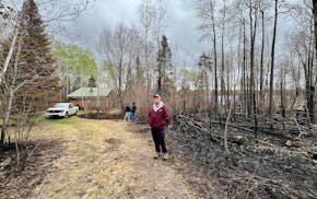 Gregg Anderson of Two Harbors on Friday stood in front of a friend's property on Salo Lake near Brimson, Minn. That property, along with his own on a