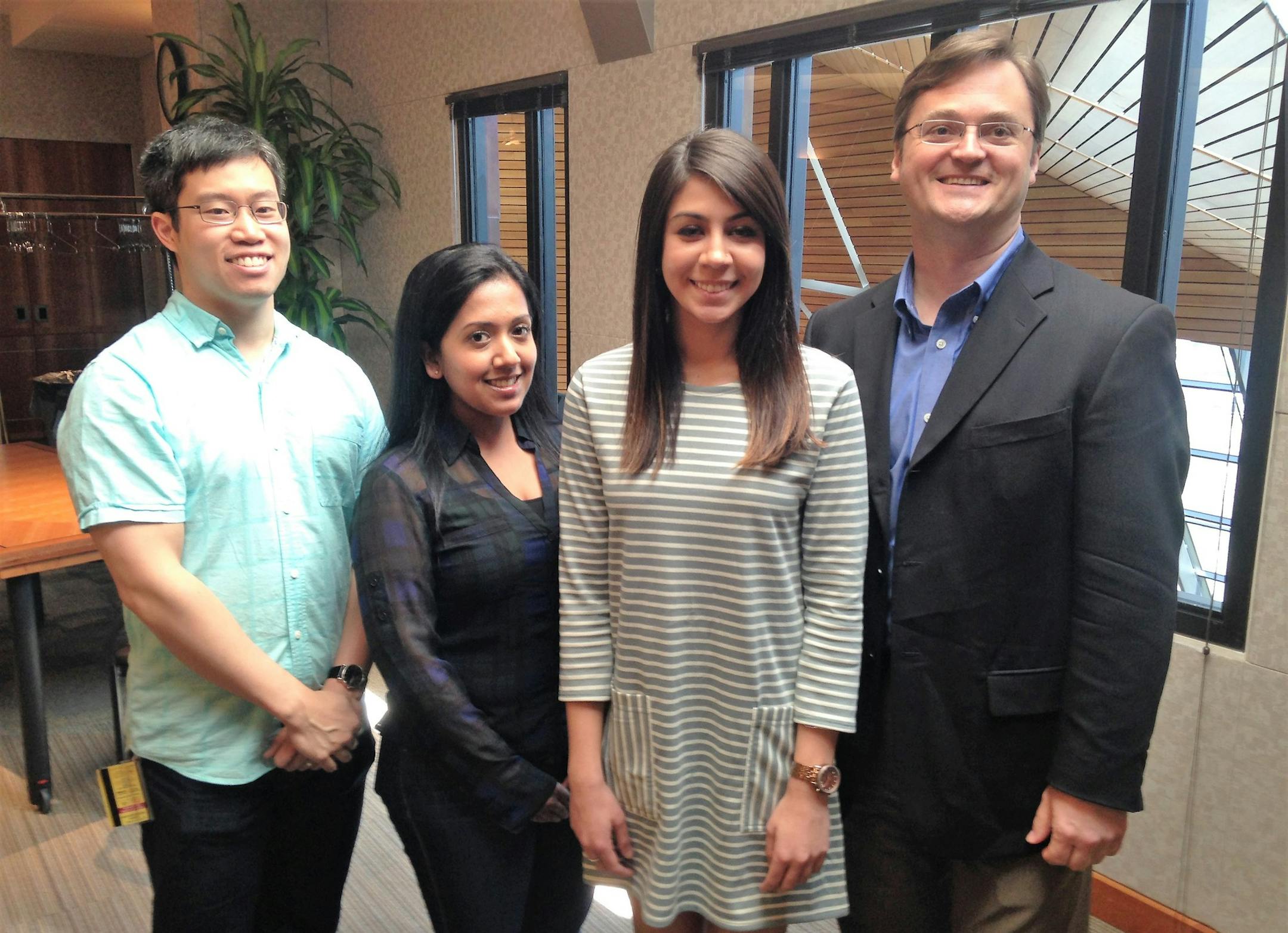 Graduate students Wilson Yu, Shawna Persaud and Zahra Masoud are leaders in the U of M's Economic Development Fellows Consulting Program this spring, standing with Tim Tripp, who oversees the program.