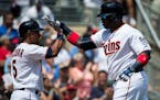 Minnesota Twins designated hitter Kennys Vargas (19) high-fived shortstop Eduardo Escobar (5) as he crossed the plate after Vargas hit a two-run homer