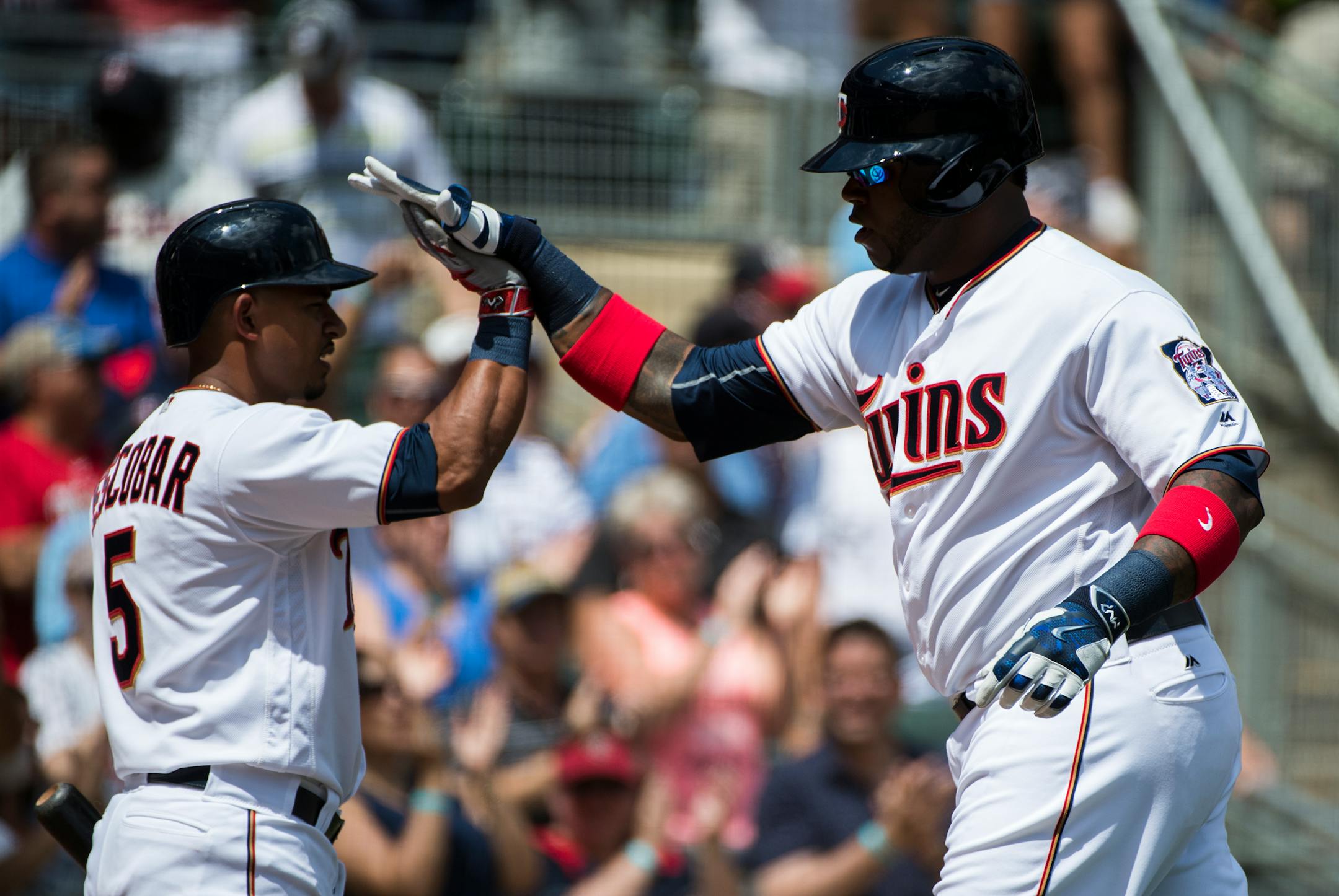 Minnesota Twins designated hitter Kennys Vargas (19) high-fived shortstop Eduardo Escobar (5) as he crossed the plate after Vargas hit a two-run homer in late July.