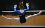 Jackie Bergeron of St. Michael-Albertville competes in the uneven parallel bars during the Minnesota State High School League gymnastics championships