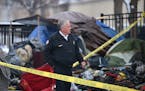 Minneapolis Fire Chief John Fruetel looked over the charred remains following an early morning fire at the Hiawatha homeless encampment Friday, Nov. 3