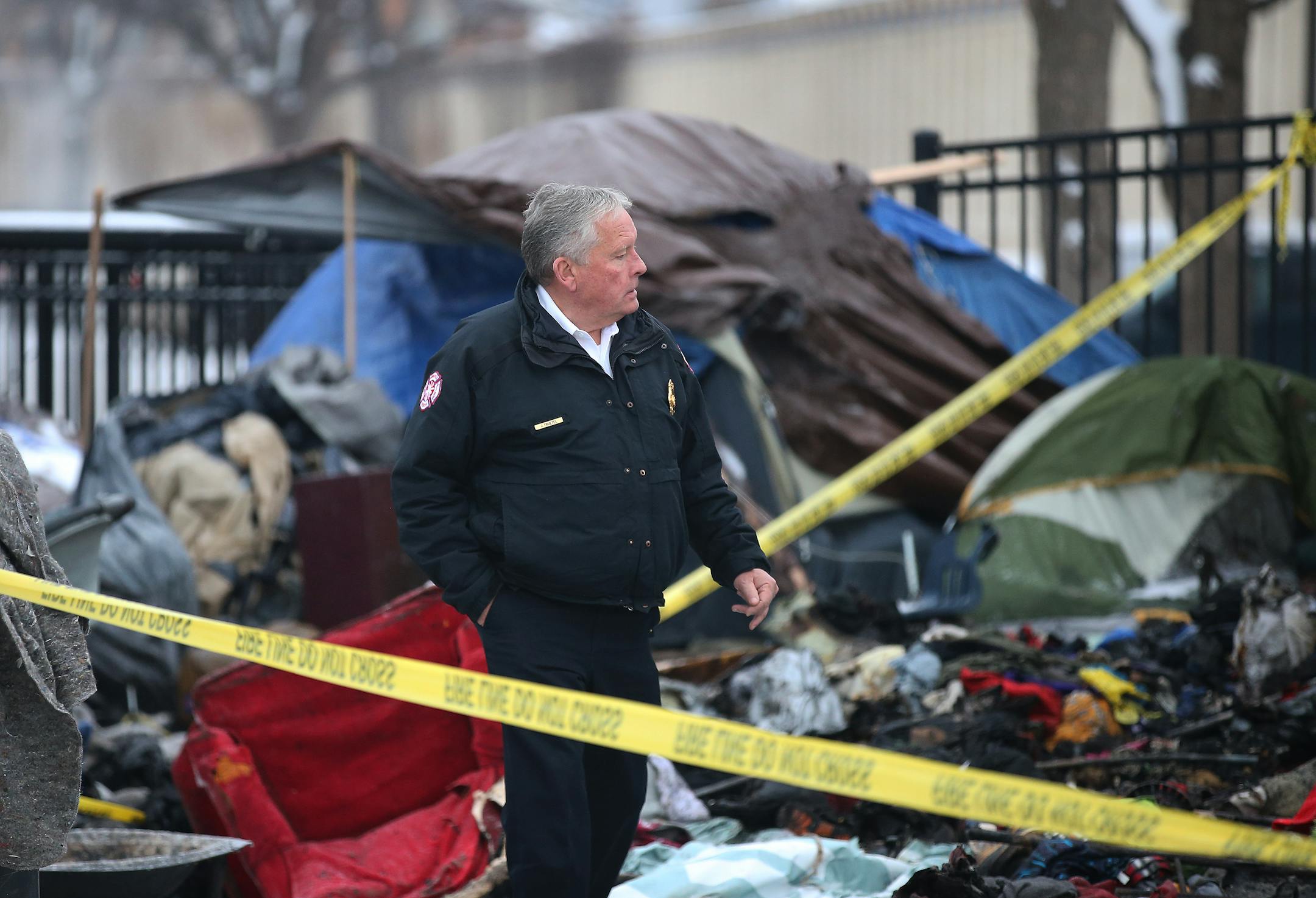 Minneapolis Fire Chief John Fruetel looked over the charred remains following an early morning fire at the Hiawatha homeless encampment Friday, Nov. 30, 2018, in Minneapolis.