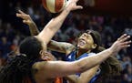 Minnesota Lynx's Seimone Agustus, right, is fouled by Connecticut Sun's Danielle Adams in the second half of a WNBA basketball game Friday, May 26, 20