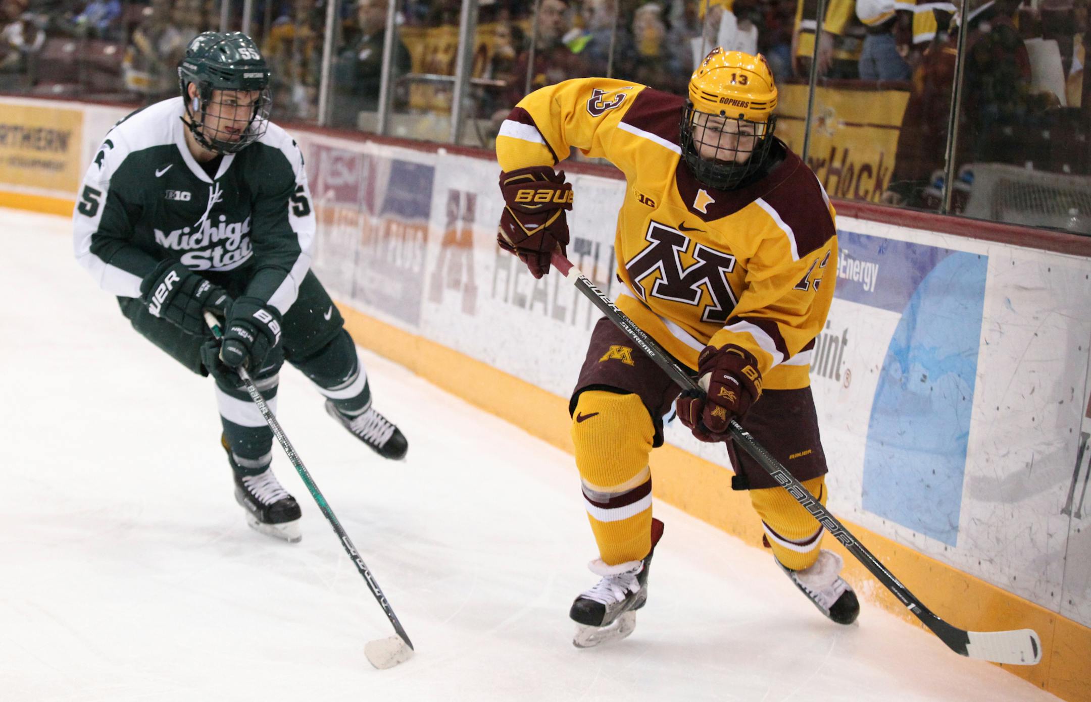 Minnesota Gophers’ Taylor Cammarata (13) and Michigan State Spartans’ Patrick Khodorenko (55) chase the puck in the first period. ] XAVIER WANG • xavier.wang@startribune.com Game action from a Big Ten Men’s hockey game between Minnesota Gophers and Michigan State Spartans on Saturday. March, 11. 2017. at Mariucci Arena on the grounds of University of Minnesota in Minneapolis.