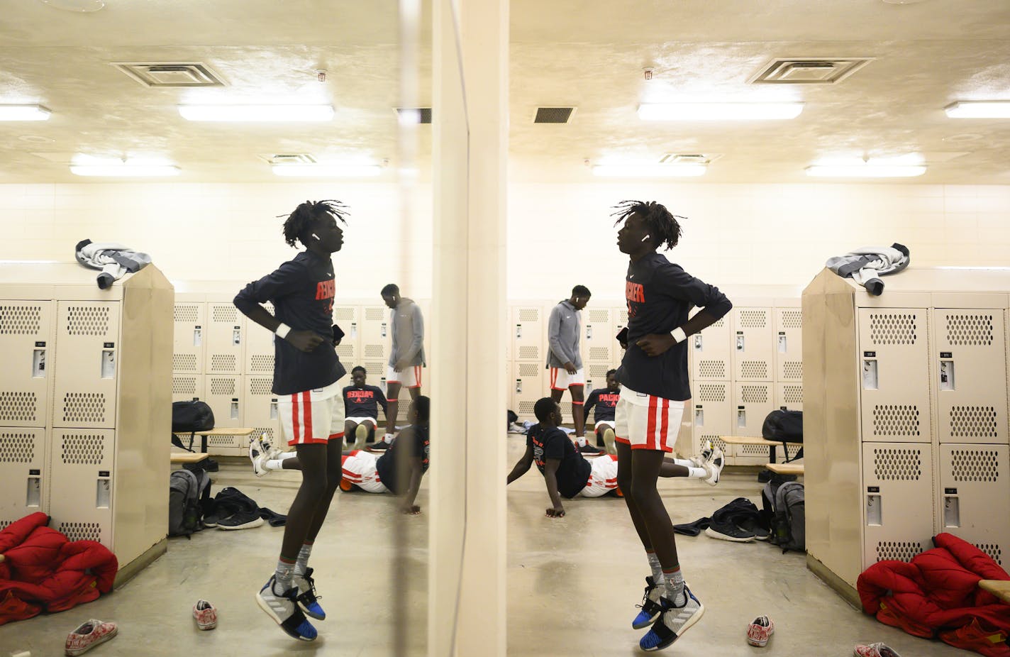 Austin senior Agwa Nywesh warmed up a a bit in the locker room before playing an away game at Faribault in late December, which they'd win 77-49. ] Aaron Lavinsky &#x2022; aaron.lavinsky@startribune.com Photos to accompany a feature on the ethnic diversification of Austin Minn., as seen through the Austin High School boys basketball and soccer programs, photographed Thursday, Sept. 19, 2019.