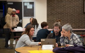 In February, Elizabeth McNamara, left, offered her assistance to Steve and Nancy Gehrenbeck-Miller as they began filling out the FAFSA form online dur