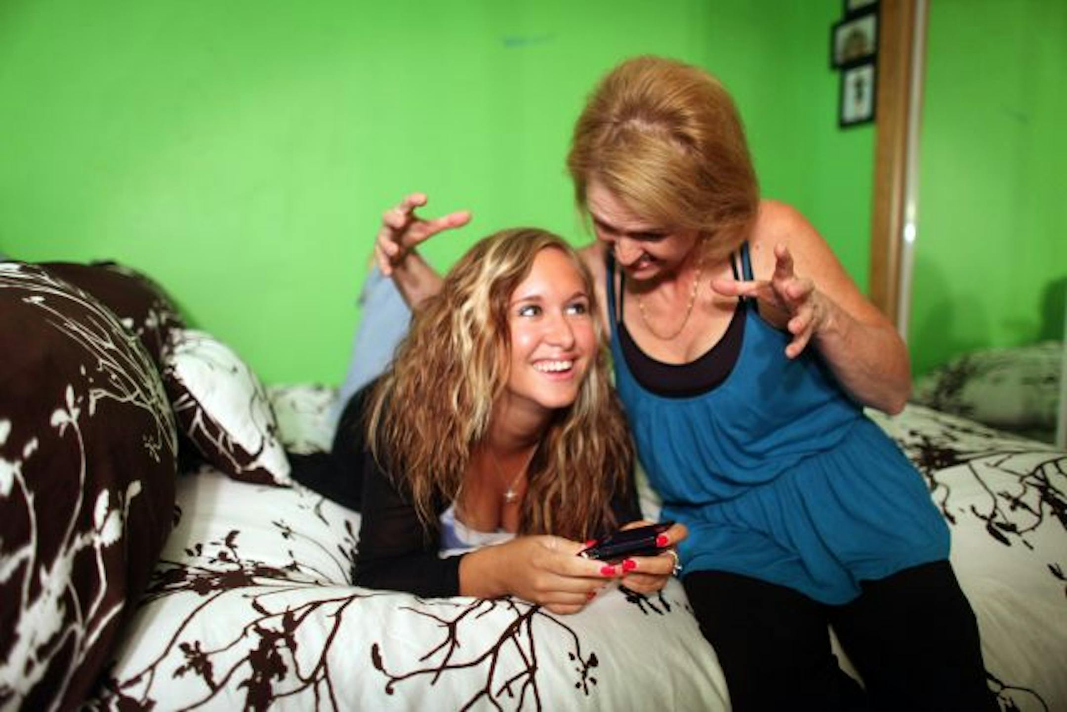 Alexa McGill, left, drives her mother, Helen, crazy with the more than 1,000 texts she sends and receives daily. Alexa will get a curfew on how late she can text at night during the school year.