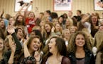 Freshman Haley Martinson, front, left to right, Madi Wheeler, and Grace Ashton join in some bleacher dancing during Pepfest for incoming freshmen in t