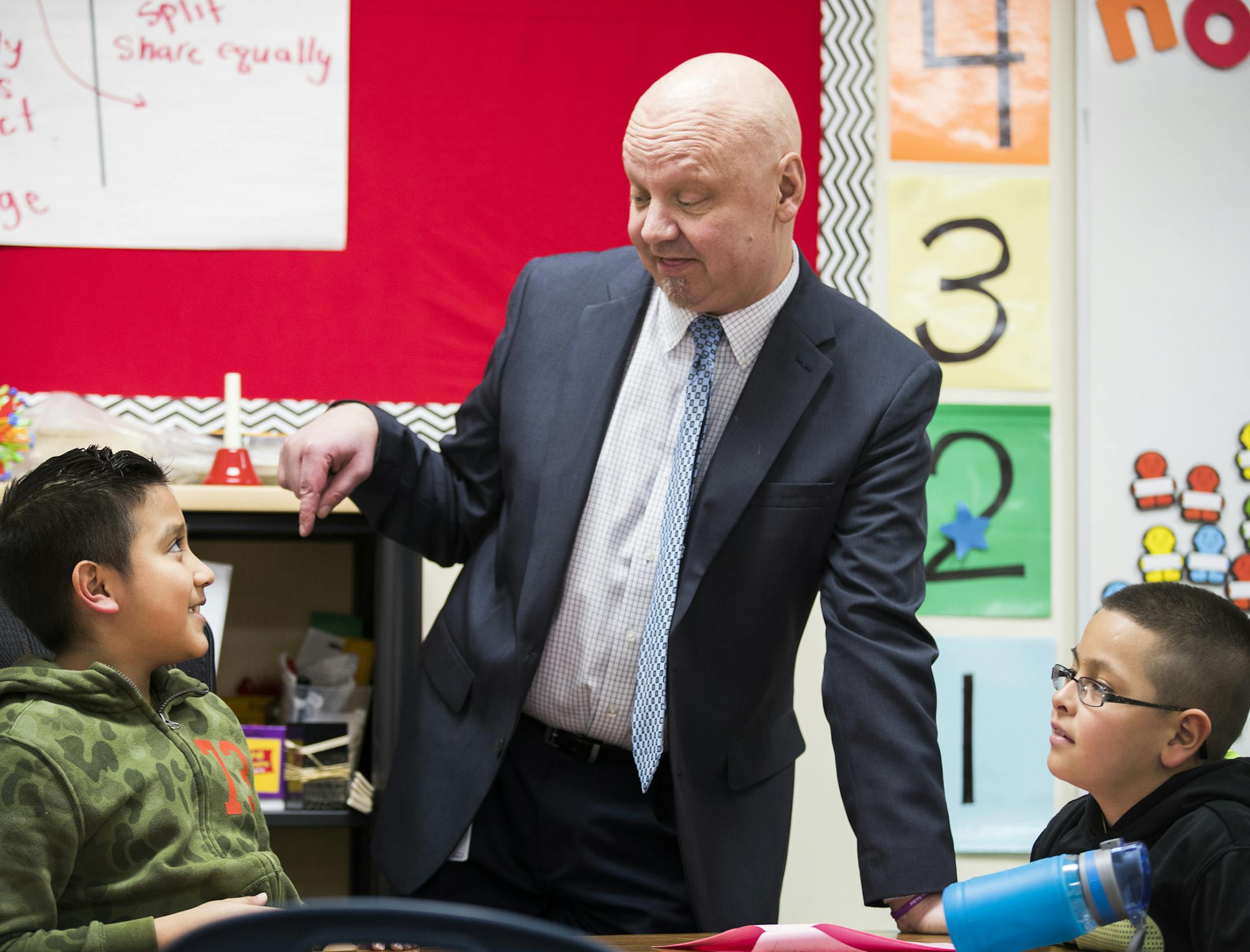 Gary Anger talks with fourth graders Allis Ayala Lopez, left, and Elvin Rascon. ] LEILA NAVIDI ï leila.navidi@startribune.com BACKGROUND INFORMATION: Shakopee Schools Interim Superintendent Gary Anger visits classrooms at Jackson Elementary School in Shakopee on Tuesday, March 13, 2018. Shakopee Schools Interim Superintendent Gary Anger faced an uphill battle after taking the helm last fall. He needed to rebuild trust of a divided district following a scandal by his predecessor, Rod Thompso