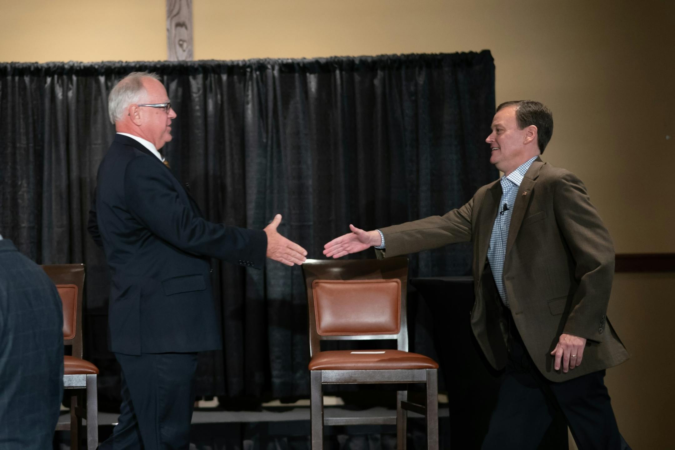 Candidates for governor Tim Walz and Jeff Johnson shoot hands at the beginning of their first debate at Grand View Lodge, Nisswa, MN. Tom Hauser of KSTP moderated the debate.