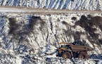 A view of Hull Rust Mine: the world's largest open pit mine, where a giant truck is seen carrying iron ore rocks Tuesday, Nov. 24, 2015, in Hibbing, M