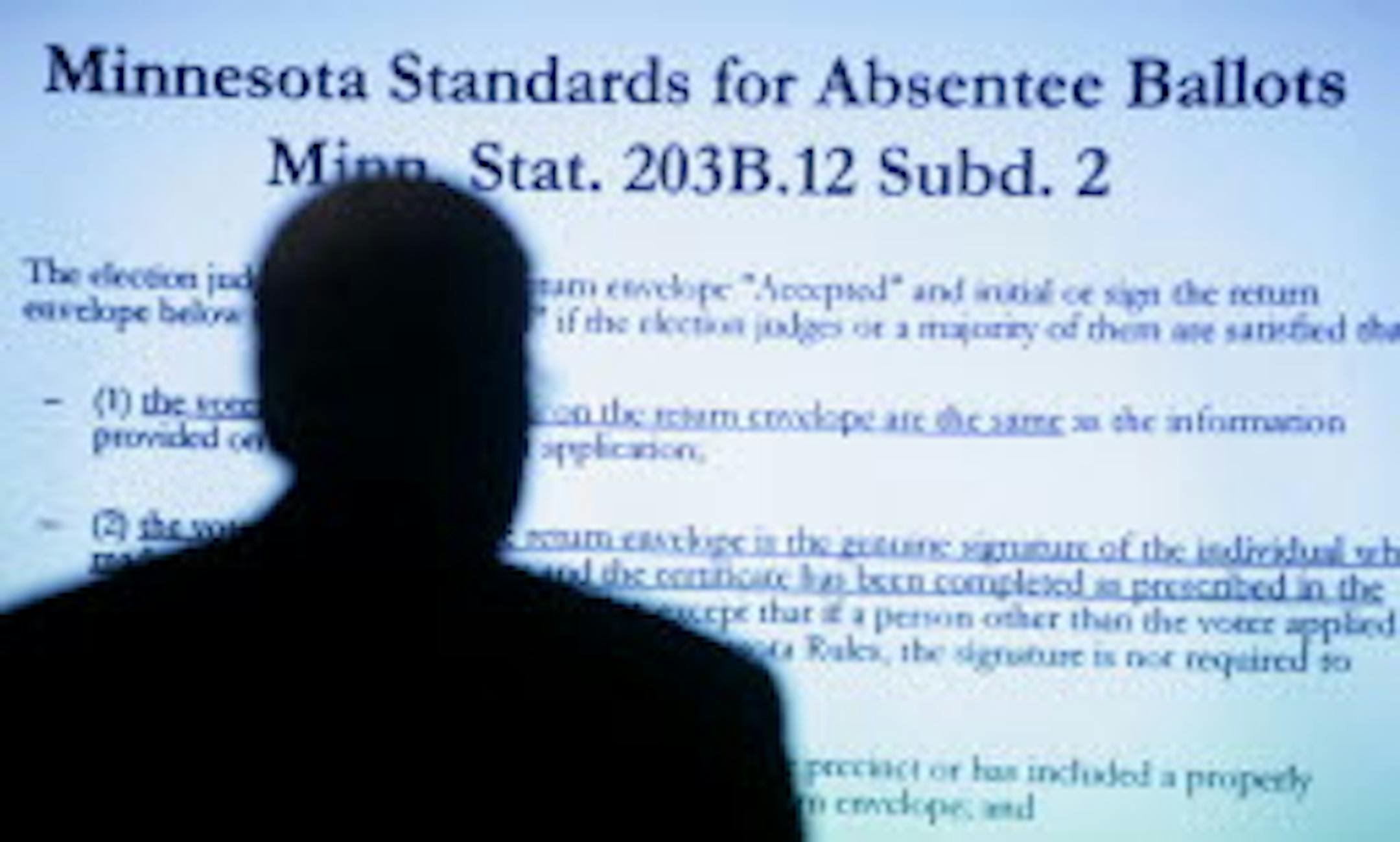 David Lillehaug, attorney for Al Franken, stands before a projection of the rules on absentee ballots during the Senate election trial on Feb. 4, 2009/Source: AP