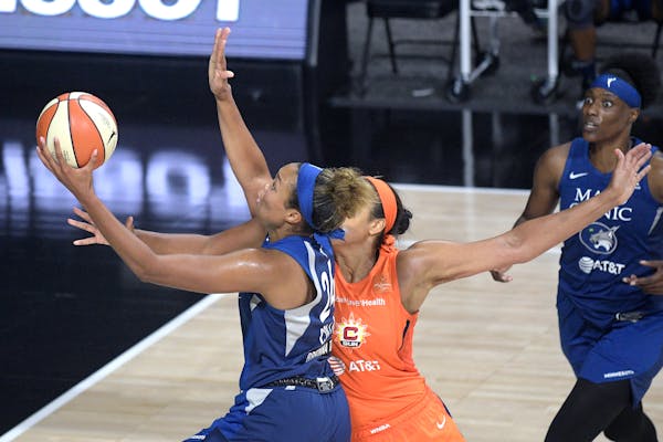 Minnesota Lynx forward Napheesa Collier (24) goes up for a shot in front of Connecticut Sun center Brionna Jones as Lynx Center Sylvia Fowles, right, 