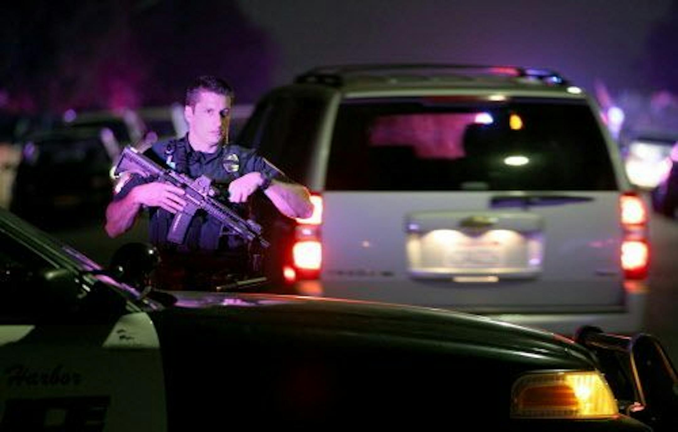 A San Diego Harbor Police officer helps to secure the scene near the corner of 39th Street and Boston Avenue in San Diego near where two San Diego Police officers were shot Thursday night, July 28, 2016.