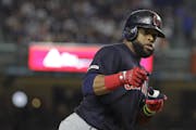 Cleveland Indians' Carlos Santana gestures to teammates as he runs the bases after hitting a two-run home run during the fourth inning of the team's b