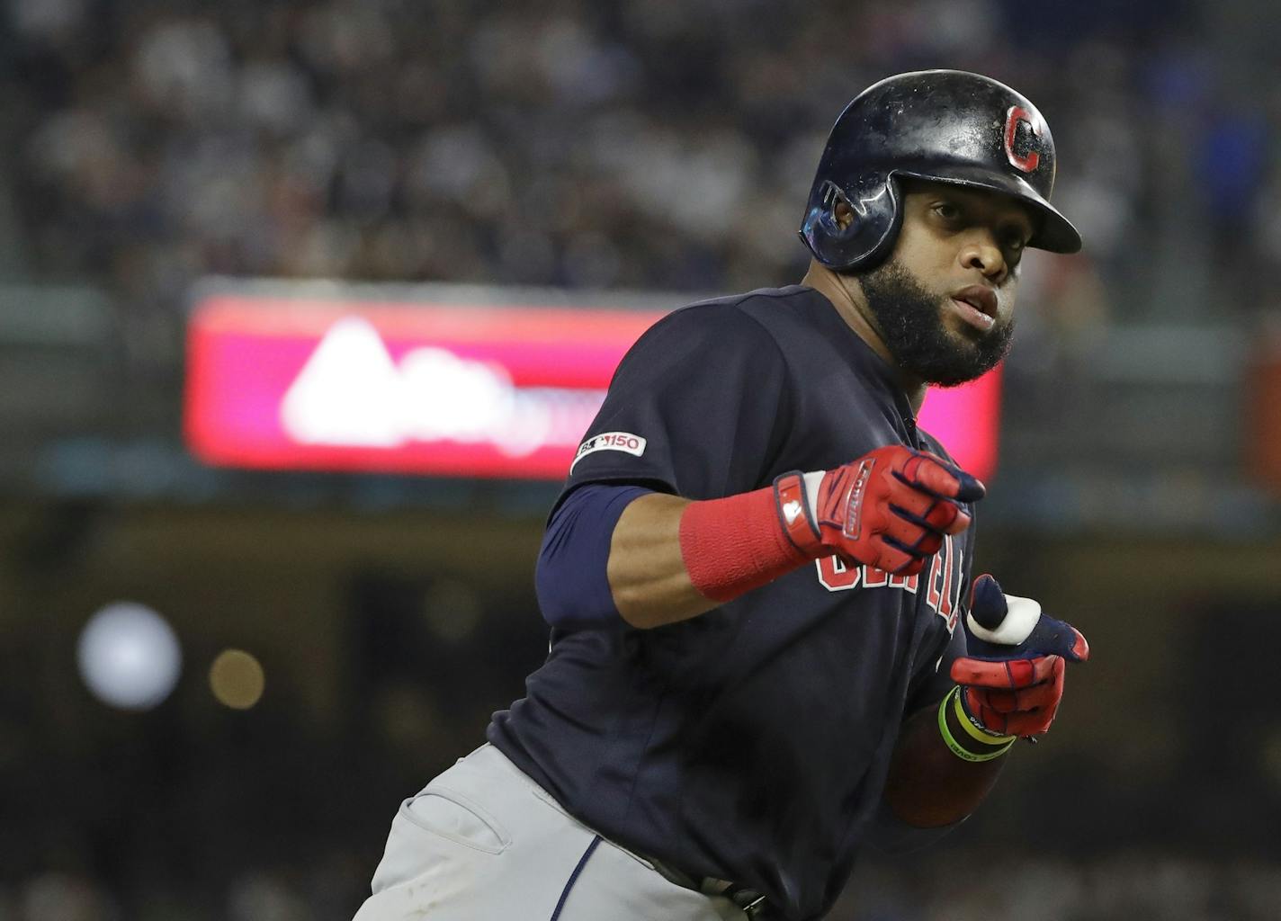 Cleveland Indians' Carlos Santana gestures to teammates as he runs the bases after hitting a two-run home run during the fourth inning of the team's baseball game against the New York Yankees on Thursday, Aug. 15, 2019, in New York. (AP Photo/Frank Franklin II)