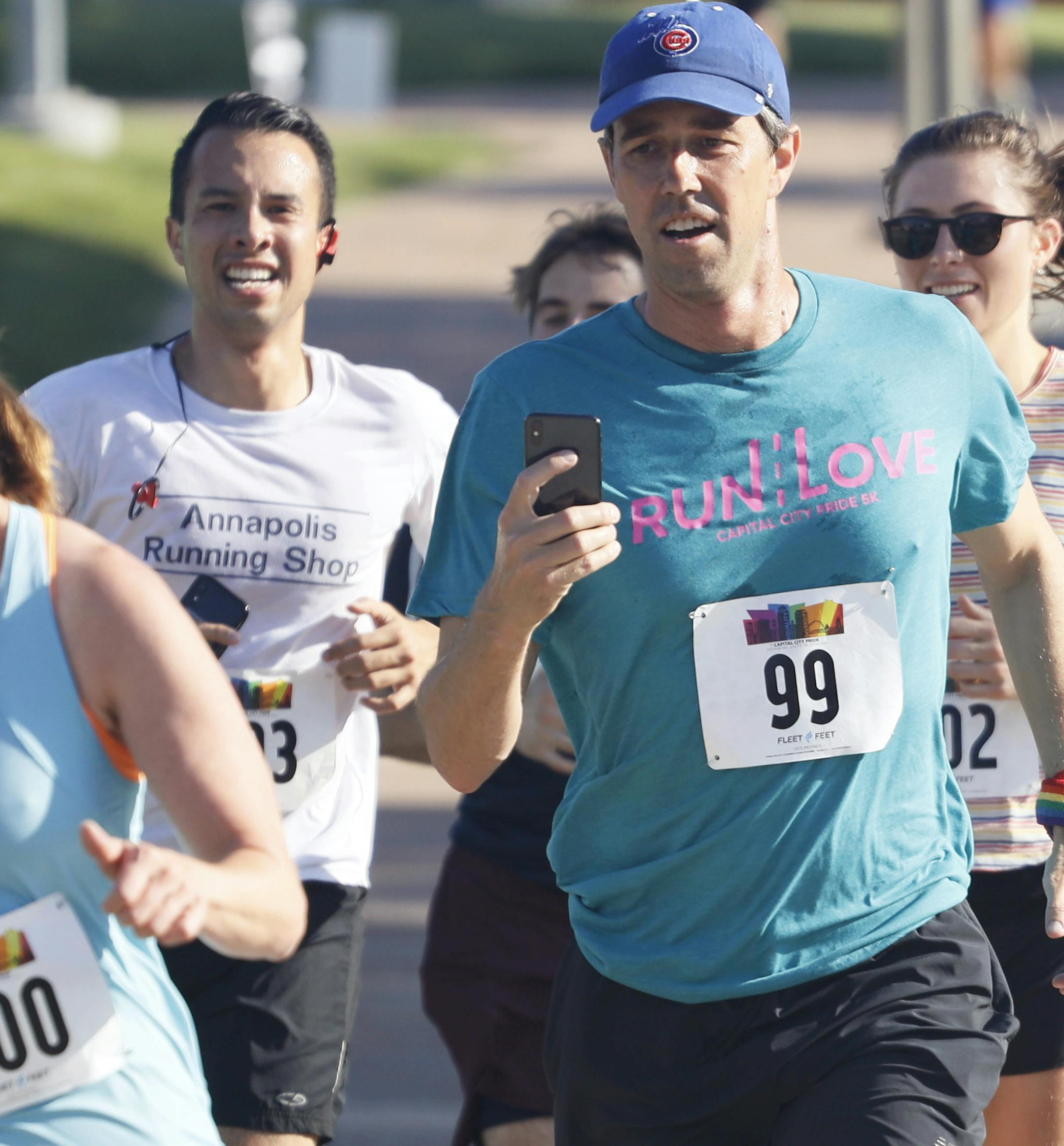 Democratic presidential candidate Beto O'Rourke, right, runs the Capital City Pride Fest Fun Run 5K with his wife Amy, left, Saturday, June 8, 2019, in Des Moines, Iowa. (AP Photo/Charlie Neibergall)