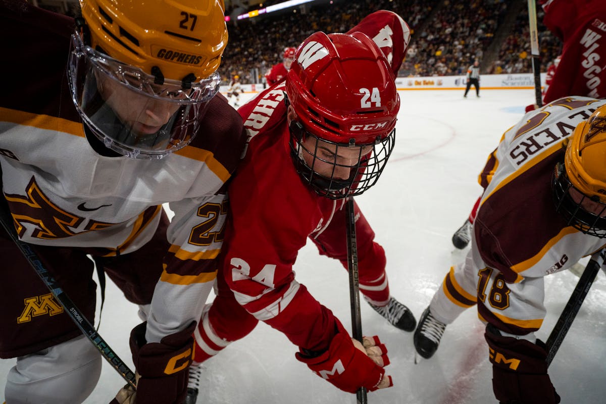 Gophers forwards Charlie Strobel, left, and Mason Nevers battled Wisconsin defenseman Anthony Kehrer for the puck during the teams' Oct. 27 meeting.