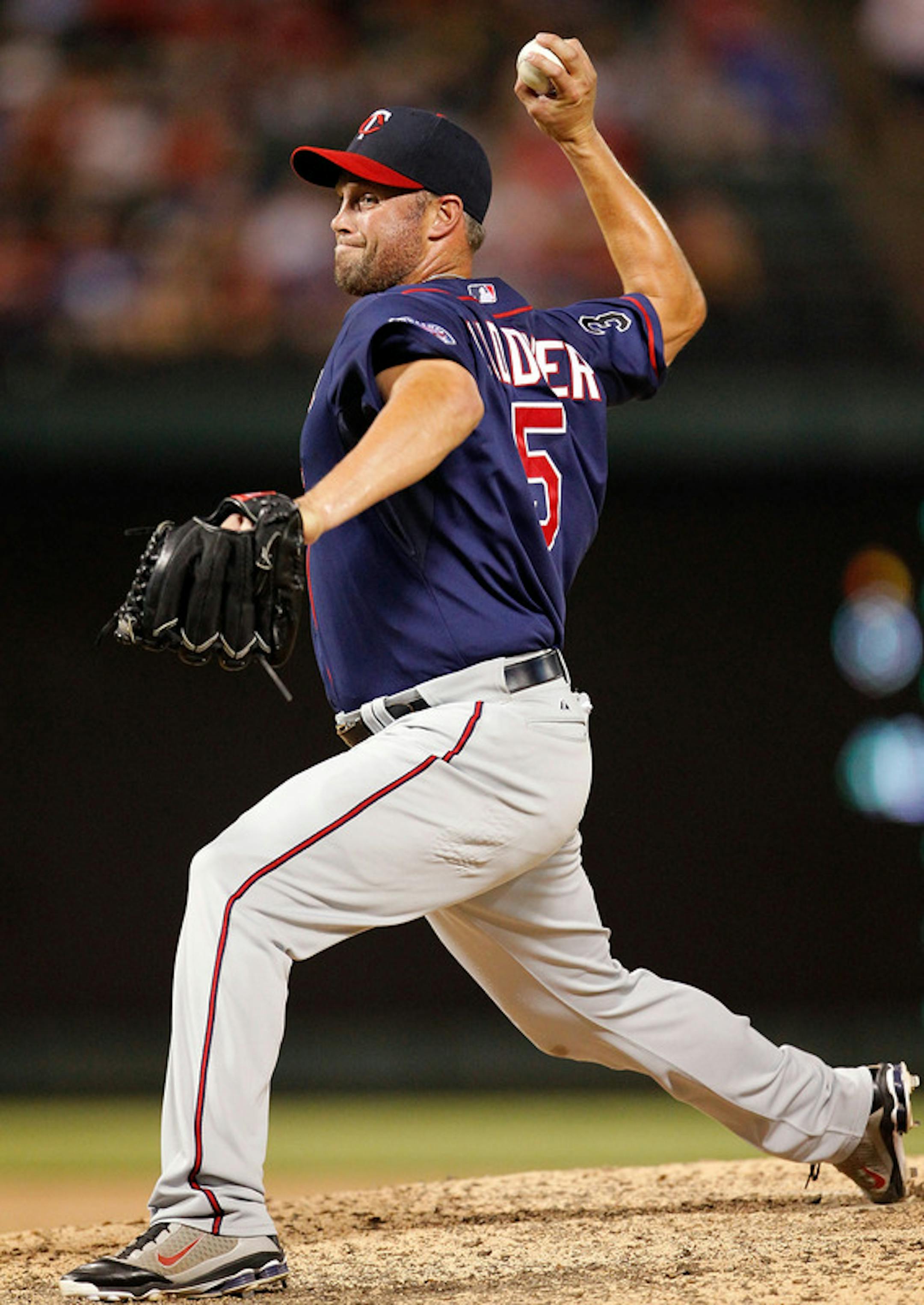 ARLINGTON, TX - JULY 25:  First baseman Michael Cuddyer #5 of the Minnesota Twins pitches against the Texas Rangers in the bottom of the eighth inning at Rangers Ballpark in Arlington on July 25, 2011 in Arlington, Texas. The Texas Rangers beat the Minnesota Twins 20-6.  (Photo by Tom Pennington/Getty Images)