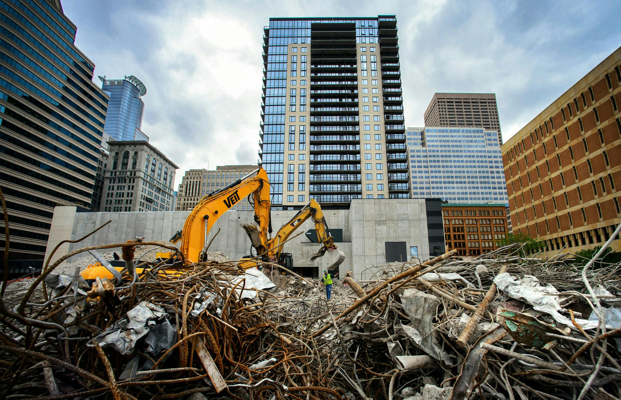 In the center, The Nic on Fifth Apartments, a 26-story luxury rental high rise. In the foreground workers clear a lot for a new Xcel Energy Headquarters. Construction in the northern stretch of Nicollet Mall where the new residents are moving in between Fourth and Fifth streets. Thursday June 12, 2014 ] GLEN STUBBE * gstubbe@startribune.com