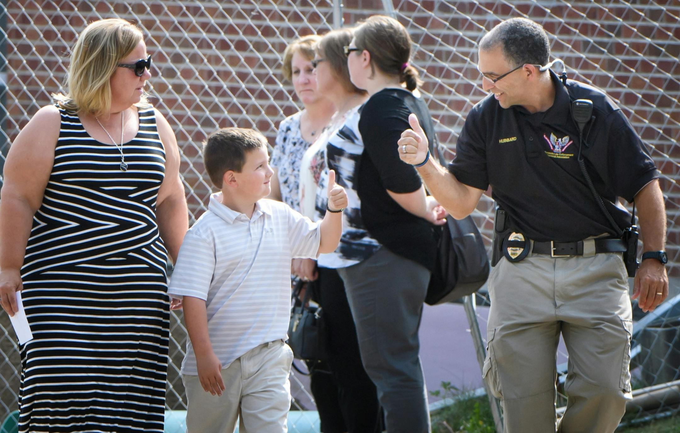Officer Mathews' son Wyatt got a thumbs up from family friend and Edina Police Sgt. Brian Hubbard as he and mother Shawn entered the Wayzata Free Church at the beginning of visitation for her husband Wayzata police officer Bill Mathews. Mathews was struck and killed by a motorist last week on Hwy. 12. Hubbard is also a good friend of the family and attends Wayzata Free Church with the Mathews family.