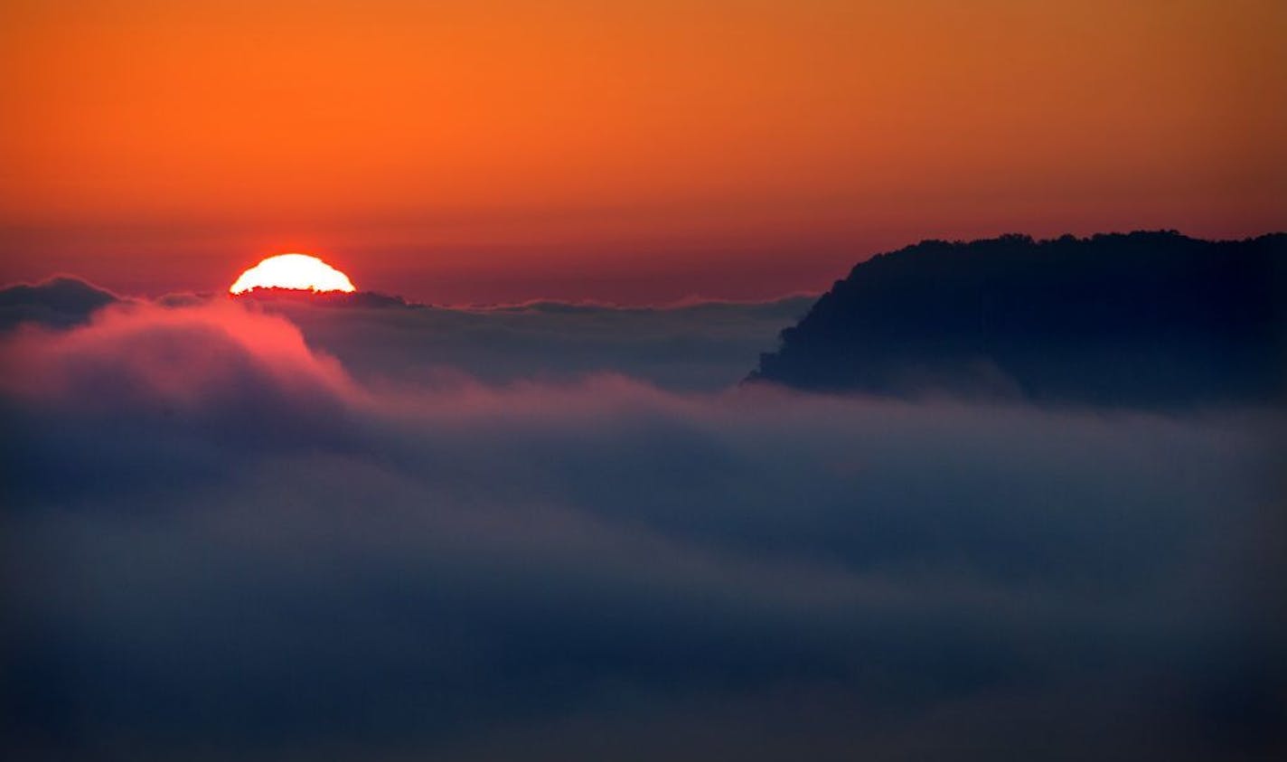 On a cool October morning, fog rises from the Mississippi River Valley at sunrise in Winona.