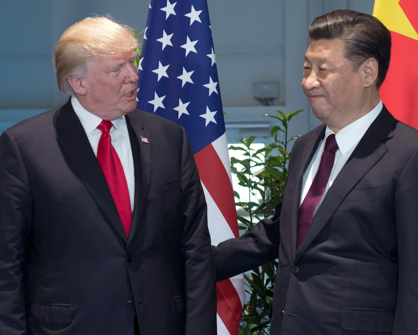 FILE - In this Saturday, July 8, 2017, file photo, U.S. President Donald Trump, left, and Chinese President Xi Jinping arrive for a meeting on the sidelines of the G-20 Summit in Hamburg, Germany. After a cordial meeting between Trump and Xi in April 2017, tensions are simmering again between the world&#xed;s two biggest economies. As U.S. and Chinese economic officials prepare to meet Wednesday, July 19, in Washington, the U.S. is weighing whether to slap tariffs on steel imports and risk setti