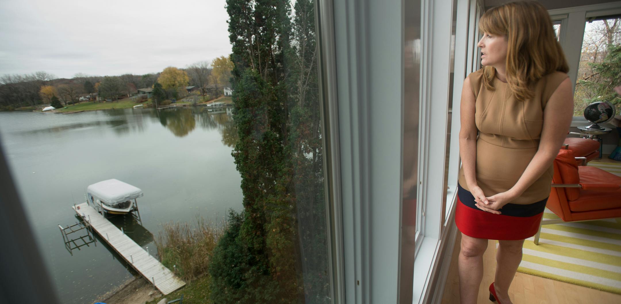 Golden Valley resident Jane McDonald Black (CQ) looks out her living room onto Sweeney Lake Wednesday afternoon. ] AARON LAVINSKY • aaron.lavinsky@startribune.com Jane McDonald Black (cq) is one of the Golden Valley residents working to save Sweeney Lake from degradation caused by nearby development. The lake was crystal clear before the construction of the I-394 and widening of Olson Memorial Highway caused salt and sediment to flow into the lake. Black was photographed in her home Wedne