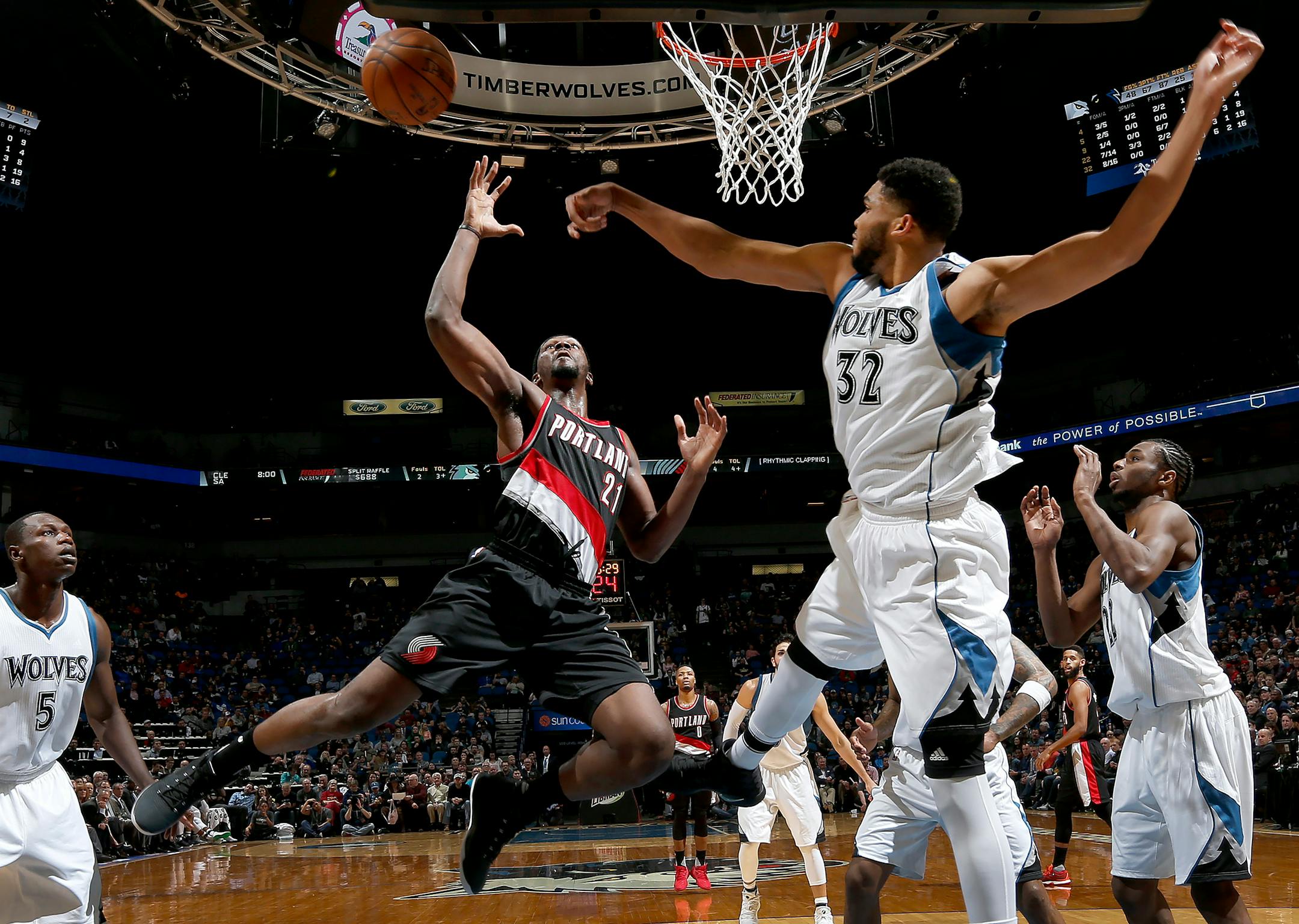Minnesota Timberwolves' Karl-Anthony Towns (32) defends a shot by Portland Trail Blazers' Noah Vonleh (21) in the third quarter on Monday, April 3, 2017 at Target Center in Minneapolis, Minn. (Carlos Gonzalez/Minneapolis Star Tribune/TNS) ORG XMIT: 1200037