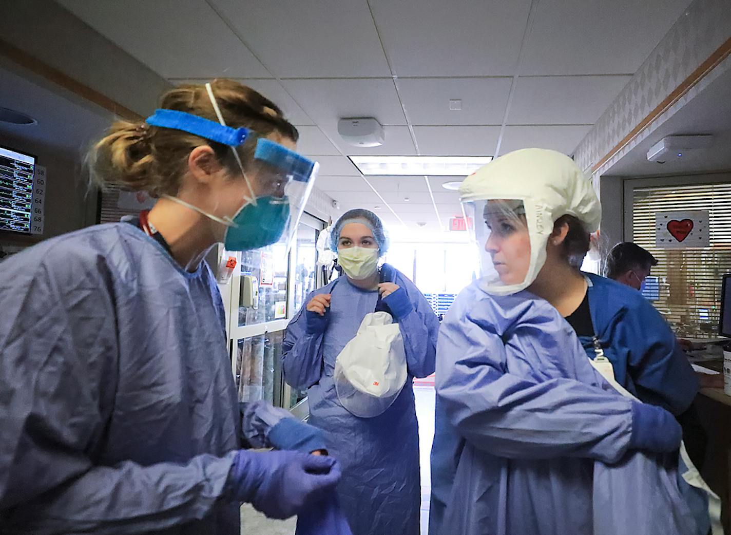 Medical staff attending to patients stricken with COVID-19 don protective equipment in a unit dedicated to treatment of the novel coronavirus at UW Health in Madison, Wis. Thursday, Nov. 5, 2020. Until recently, the hospital had four wings for coronavirus patients. To meet growing demand, it added another wing. (John Hart/Wisconsin State Journal via AP)