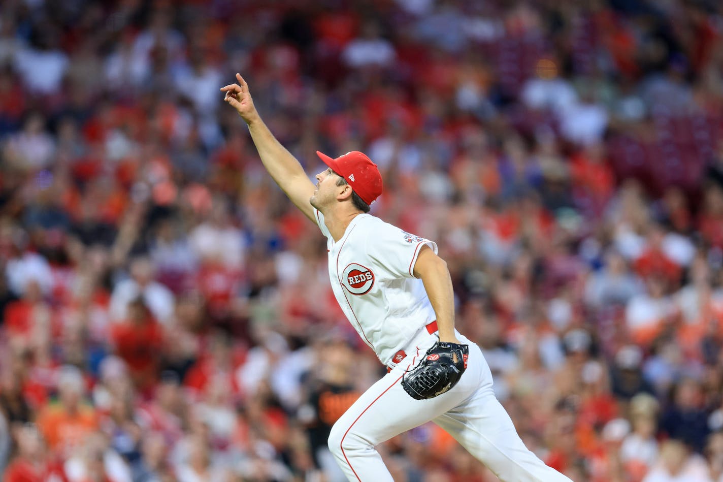 Cincinnati Reds' Tyler Mahle reacts as he plays the field during a baseball game against the Baltimore Orioles in Cincinnati, Saturday, July 30, 2022. The Reds won 8-2. (AP Photo/Aaron Doster)