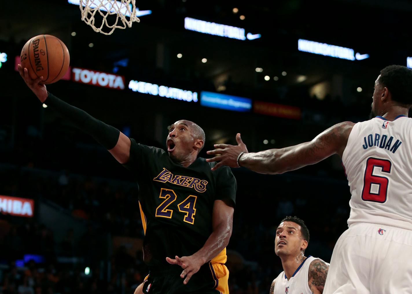 The Los Angeles Lakers' Kobe Bryant (24) slips past the Los Angeles Clippers' DeAndre Jordan (6) for a layup in the second quarter at Staples Center in Los Angeles on Friday, Oct. 31, 2014. (Robert Gauthier/Los Angeles Times/MCT)