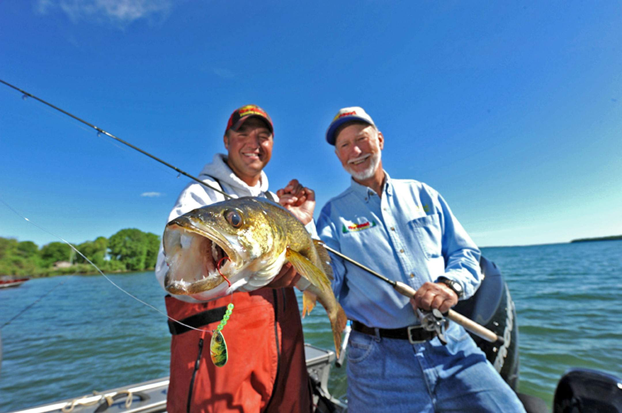 Professional angler and guide Tony Roach, left, with his famous professional angler, guide and great-uncle Gary Roach, with the object of their common affection: a big walleye.