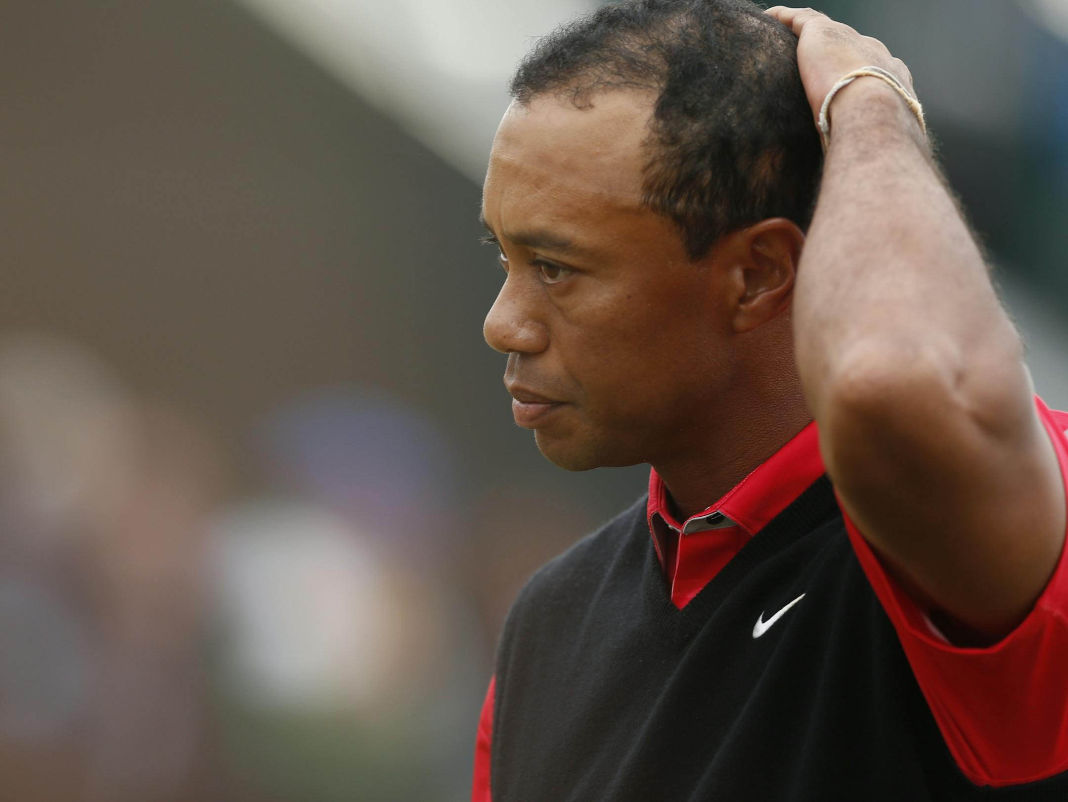 Tiger Woods of the United States reacts on the 18th green at the end of the final round of the British Open Golf Championship at Muirfield, Scotland, Sunday July 21, 2013. (AP Photo/Matt Dunham)