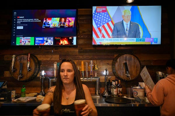 As workers served patrons at Alibi Drinkery in Lakeville on Wednesday, Dec. 16, Gov. Tim Walz’s address was broadcast in the background. Restaurants
