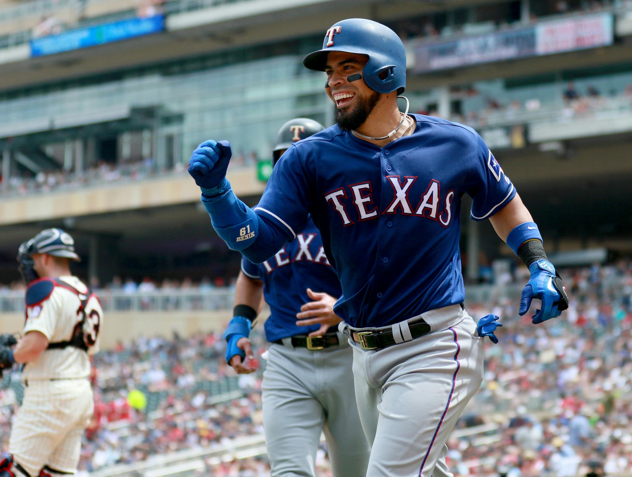 The Texas Rangers Robinson Chirinos celebrates his two-run third inning homer off Twins reliever Matt Magill Saturday.