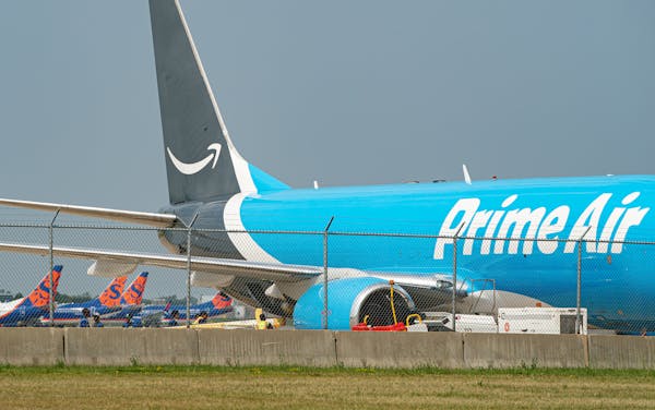 Workers unloaded a Prime Air jet after it landed at Minneapolis-St. Paul International Airport. Sun Country's deal with Amazon is helping the airline 