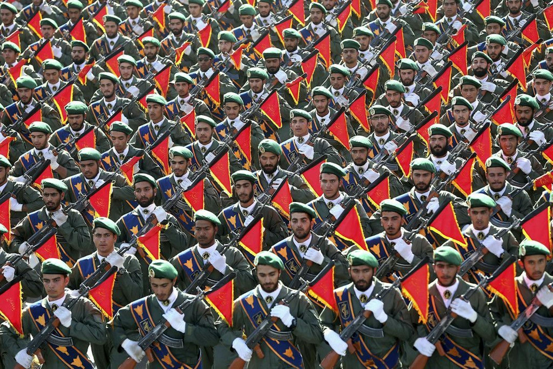 FILE - In this Sept. 21, 2016 file photo, Iran's Revolutionary Guard troops march in a military parade marking the 36th anniversary of Iraq's 1980 invasion of Iran, in front of the shrine of late revolutionary founder Ayatollah Khomeini, just outside Tehran, Iran. The Trump administration is preparing to designate Iran's Revolutionary Guards Corps a "foreign terrorist organization" in an unprecedented move that could have widespread implications for U.S. personnel and policy. U.S. Officials say