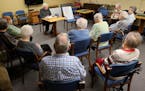 Marvin Kauffman reads to a group of 10 St. Francis residents in Eau Claire. Mandatory credit: Dan Reiland / Eau Claire Leader Telegram