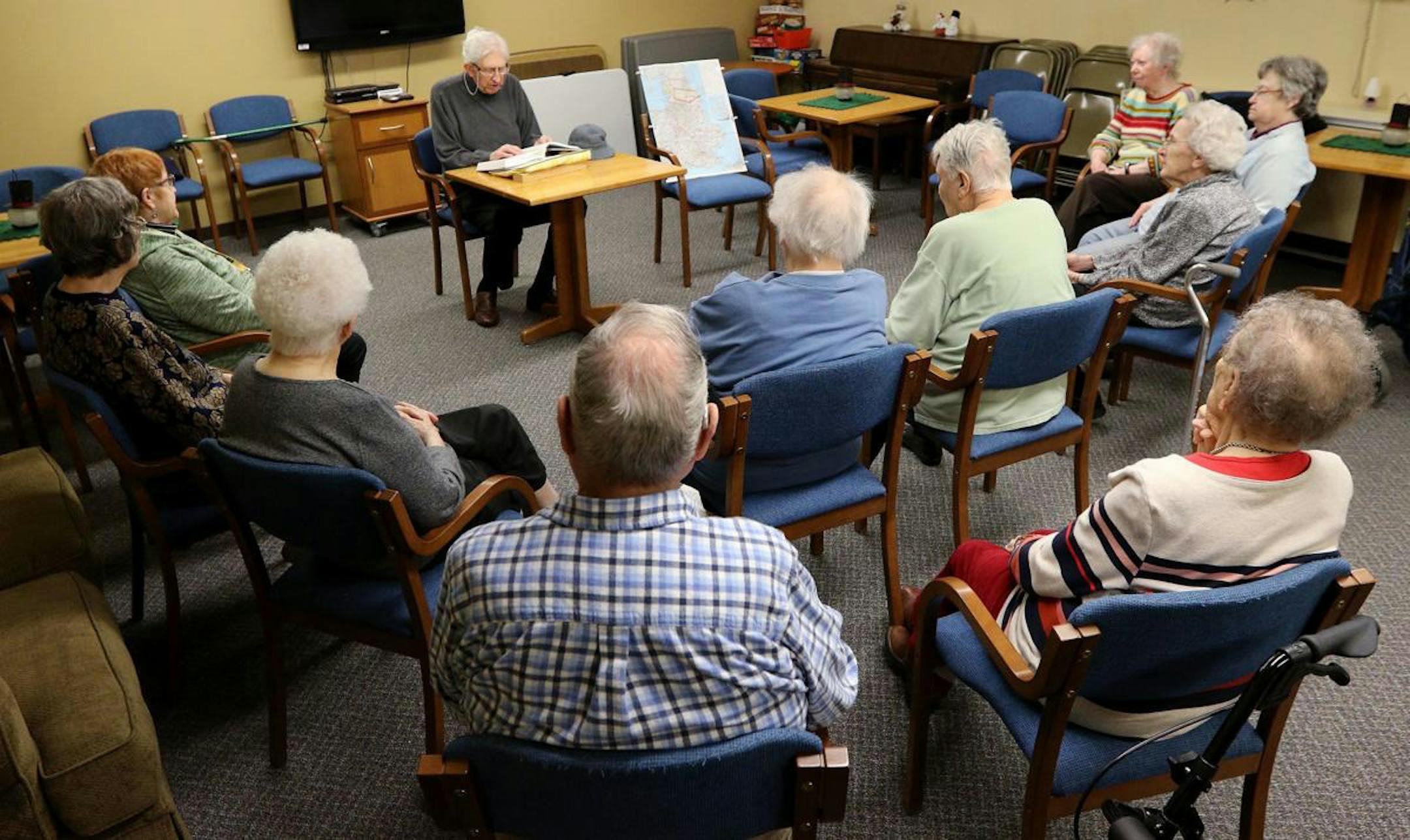 Marvin Kauffman reads to a group of 10 St. Francis residents in Eau Claire. Mandatory credit: Dan Reiland / Eau Claire Leader Telegram