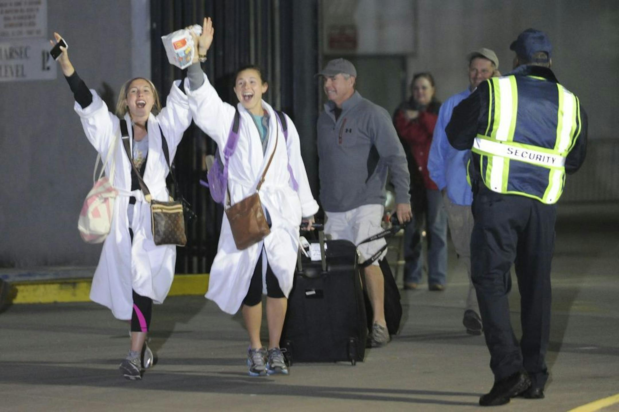 Kendall Jenkins, left, of Houston, celebrates with a friend after getting off the Carnival Triump in Mobile, Ala., Thursday, Feb. 14, 2013. The ship with more than 4,200 passengers and crew members has been idled for nearly a week in the Gulf of Mexico following an engine room fire.